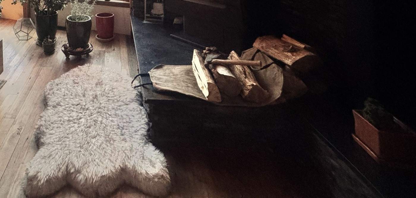 Sheepskin and firewood by the hearth